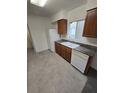 Kitchen with wood cabinets, granite counters, and appliances at 12954 Fennway Ridge Dr, Riverview, FL 33579