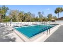Inviting swimming pool surrounded by a well-maintained fence and patio area for endless summer fun at 3203 Audubon Ct, Tarpon Springs, FL 34688