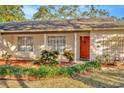 House exterior with red door and well-maintained landscaping at 3826 Highgate Dr, Valrico, FL 33594