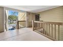 Interior hallway with wooden railings and access to unit at 9481 Highland Oak Dr # 807, Tampa, FL 33647