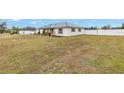 House exterior showcasing a green metal roof and a spacious lawn at 2413 Crestview Rd, Wimauma, FL 33598