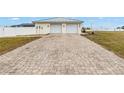 Two-car garage with paver driveway and attached to the house at 2413 Crestview Rd, Wimauma, FL 33598