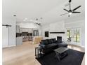Open concept living room with kitchen, island, and fireplace at 2609 65Th E St, Bradenton, FL 34208
