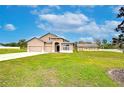 Two-story house with a three-car garage and lush lawn at 3406 Ranchdale Dr, Plant City, FL 33566