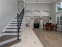 Bright and spacious entryway with staircase, wood flooring, and access to the living room at 4709 Corsage Dr, Lutz, FL 33558