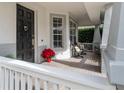 Relaxing front porch with white railing, comfortable seating, and potted plants at 4709 Corsage Dr, Lutz, FL 33558