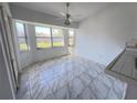Breakfast nook with tile floors and a large window overlooking the backyard at 491 Allworthy St, Port Charlotte, FL 33954
