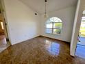 Bright dining room with tile floors and an arched window at 491 Allworthy St, Port Charlotte, FL 33954