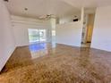 Spacious living room with tile floors and sliding doors leading to the pool at 491 Allworthy St, Port Charlotte, FL 33954