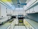 Galley kitchen with stainless steel appliances and light wood cabinets at 4910 Bay Ne St # 103, St Petersburg, FL 33703