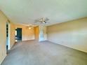 Spacious living room showcases neutral paint, carpet, and a wide view into other rooms at 4910 Bay Ne St # 103, St Petersburg, FL 33703