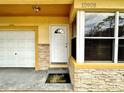 Front entrance with stone accents and welcome mat at 10908 W Elbow Dr, Tampa, FL 33612