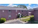 Brick building exterior with walkway, landscaping, and parking at 1122 84Th N Ter # C, St Petersburg, FL 33702