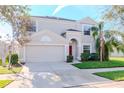 Two-story house with red door, attached garage, and landscaped lawn at 13167 Royal Pines Ave, Riverview, FL 33579