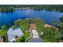 House on a lake with a pool and lush landscaping at 3205 Pleasant Lake Dr, Tampa, FL 33618