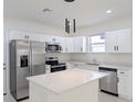 Modern kitchen with white cabinets, stainless steel appliances, and quartz countertops at 4226 Elwood Rd, Spring Hill, FL 34609