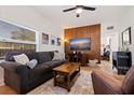 Living room with wood-paneled accent wall, comfy seating, and flat-screen TV at 826 53Rd N Ter, St Petersburg, FL 33703