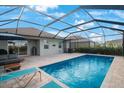 Spacious screened-in pool area with patio seating, barbecue, and clear view of the inviting pool at 11312 Gallatin Trl, Parrish, FL 34219
