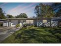 Charming Ranch home with a light green exterior, and nicely landscaped lawn at 1829 West Dr, Clearwater, FL 33755