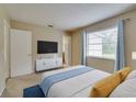 Bright bedroom with a comfortable bed and large window at 2906 Martha Ln, Land O Lakes, FL 34639