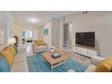 Spacious living room featuring a comfortable seating area and large TV at 2906 Martha Ln, Land O Lakes, FL 34639