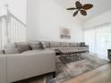 Spacious living room with large sectional sofa and hardwood floors at 3077 Branch, Clearwater, FL 33760