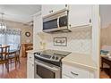 Stainless steel appliances and white shaker cabinets in kitchen at 35827 Verda Dr, Zephyrhills, FL 33541