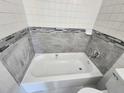 Bathroom featuring a bathtub with gray tile and a tiled backsplash at 4735 22Nd N Ave, St Petersburg, FL 33713
