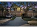 Attractive townhouse at night, well lit, two-car garage at 4950 Pond Ridge Dr, Riverview, FL 33578