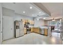 Modern kitchen with stainless steel appliances and light wood cabinets at 4950 Pond Ridge Dr, Riverview, FL 33578