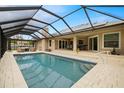 Inviting screened pool area with spacious patio and ample seating at 1165 Curlew Rd, Dunedin, FL 34698