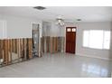 Renovation project: living room with exposed walls and tiled floors at 215 176Th Terrace E Dr, Redington Shores, FL 33708