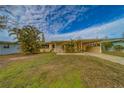 Ranch-style home with palm trees and a spacious yard at 2480 Del Rio Way, Dunedin, FL 34698