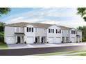 Townhouse exterior, modern white siding, two-car garages, and attractive landscaping at 32619 Turtle Grace Loop, Wesley Chapel, FL 33545