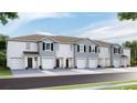 Townhouse exterior, modern gray siding, two-car garages, appealing curb appeal at 32619 Turtle Grace Loop, Wesley Chapel, FL 33545