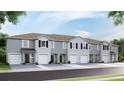 Townhouse exterior, gray siding, two-car garages, and a charming streetscape at 32619 Turtle Grace Loop, Wesley Chapel, FL 33545