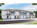 New townhome community with attached garages and neutral-color exteriors at 477 Mangrove Shade Cir, Apollo Beach, FL 33572