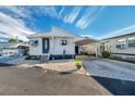 Quaint mobile home with carport, landscaping, and paved driveway at 4851 W Gandy Blvd # B6 L3, Tampa, FL 33611