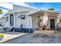 Nice Florida mobile home with carport, landscaping, and paved driveway at 4851 W Gandy Blvd # B6 L3, Tampa, FL 33611