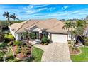 Single-story home with tile roof, landscaped yard, and attached garage at 5076 La Costa Island Ct, Punta Gorda, FL 33950