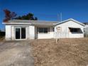 Front view of a single story home with a sliding glass door at 6307 Langston Ave, New Port Richey, FL 34653