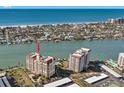 Aerial view showcasing condo building and waterway at 700 Island Way # 704, Clearwater Beach, FL 33767