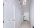 Bright and airy entryway with tile flooring, staircase, and coat closet at 7014 King Creek Dr, Sun City Center, FL 33573
