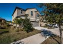 Two-story house with gray siding, two-car garage, landscaping, and driveway at 7014 King Creek Dr, Sun City Center, FL 33573