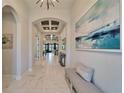Entryway with a bench, large art piece, and views into the living area at 9152 Warm Springs Cir, Parrish, FL 34219