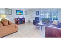 Living room with tiled floors, leather furniture, and a fireplace at 9156 142Nd St, Seminole, FL 33776