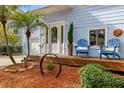 Inviting front porch with blue Adirondack chairs and a wooden deck at 1049 S Pointe Alexis Dr, Tarpon Springs, FL 34689