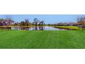 Spacious backyard with a pond view and lush green grass at 10827 High Noon Trl, Parrish, FL 34219