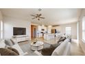 Open-concept living area with a kitchen, island, and dining space at 10827 High Noon Trl, Parrish, FL 34219