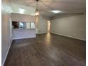 Spacious open-plan living room with hardwood floors, neutral walls, and sight lines to the kitchen at 12908 Brant Tree Dr, Riverview, FL 33579